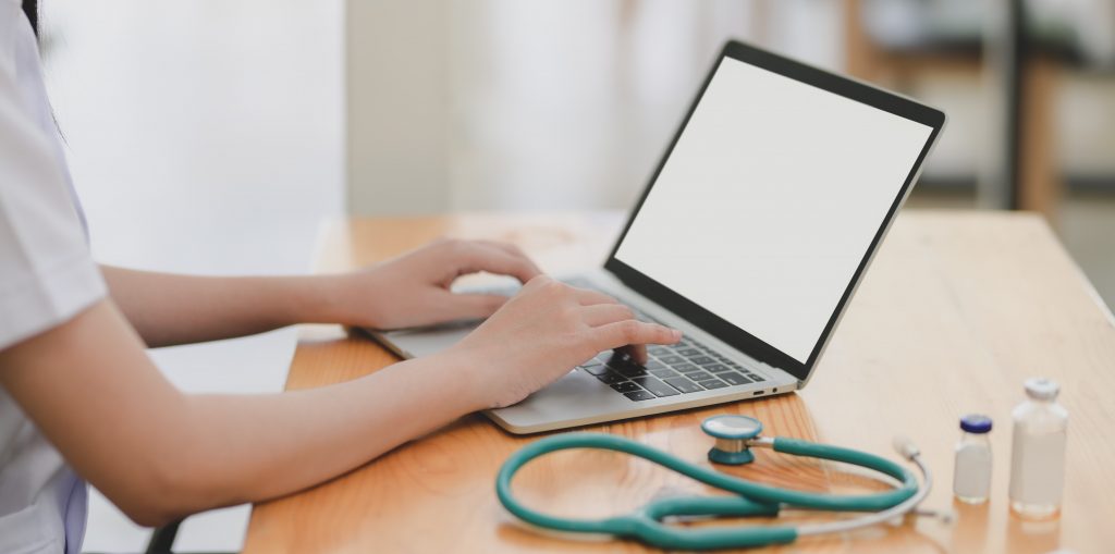 Medic sitting next to a computer